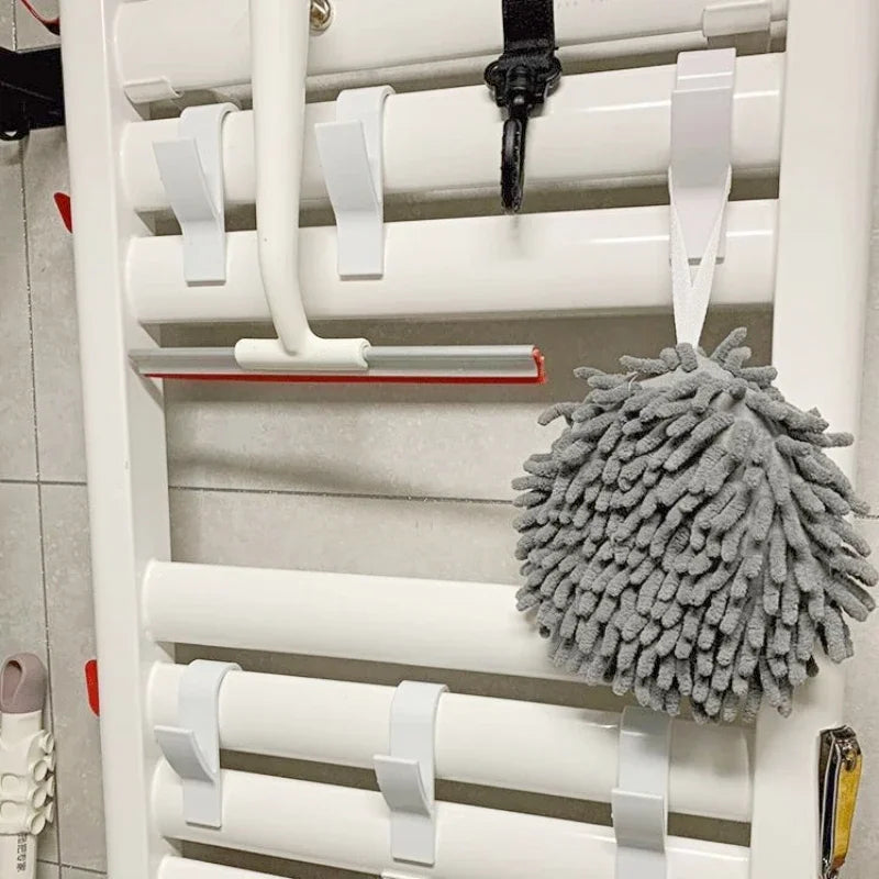 FanzyMarket bathroom heated radiator towel hooks with rail hangers and clips for towels, scarves, and clothes in a home bathroom setting.