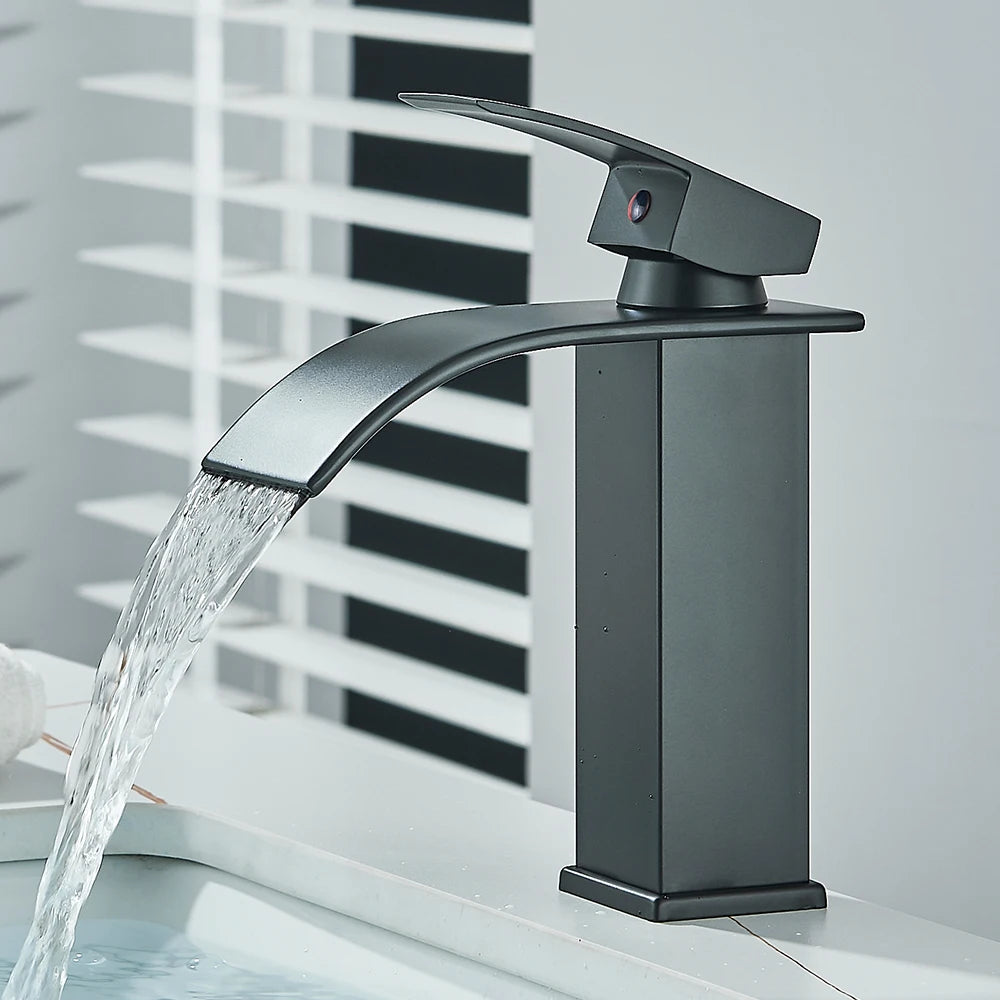 Matte black waterfall basin faucet by FanzyMarket, deck-mounted single-handle mixer tap for bathroom sink with hot and cold water.