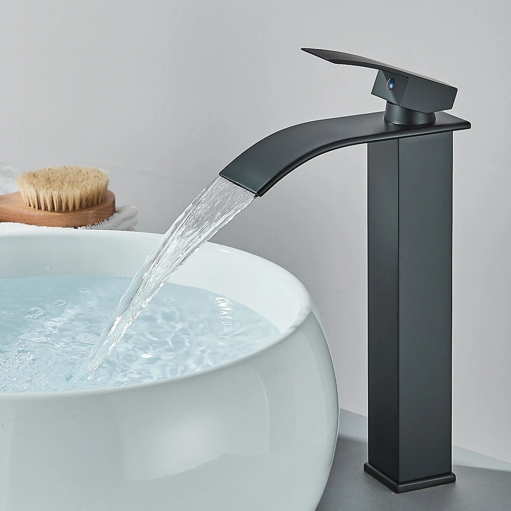 Matte black waterfall basin faucet by FanzyMarket, deck-mounted single-handle mixer tap with hot and cold water for bathroom sink.