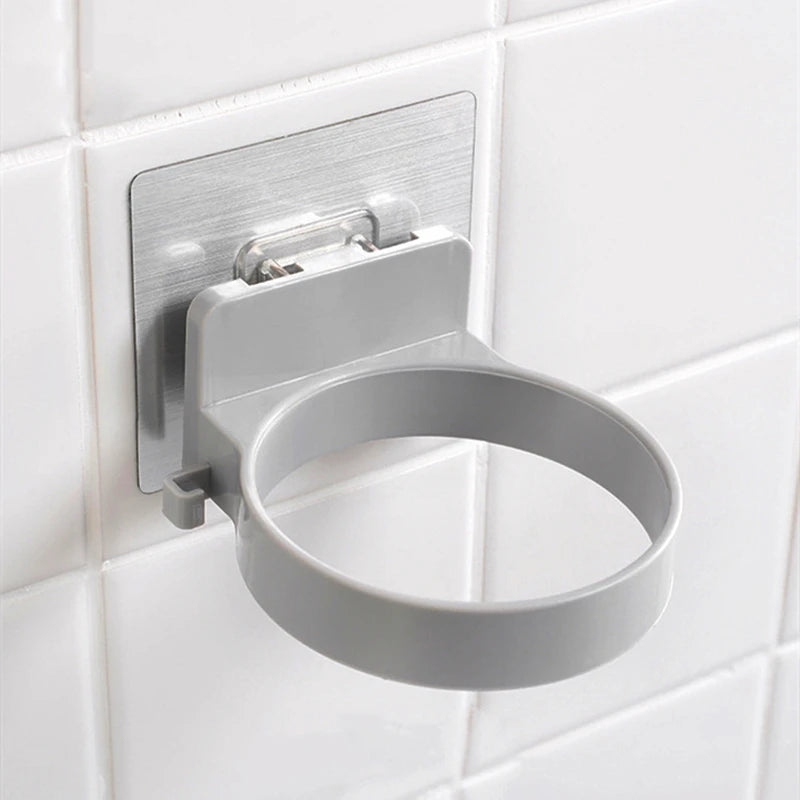 FanzyMarket wall-mounted stainless steel hair dryer holder with spiral design and nail-free adhesive, 12x10 cm.