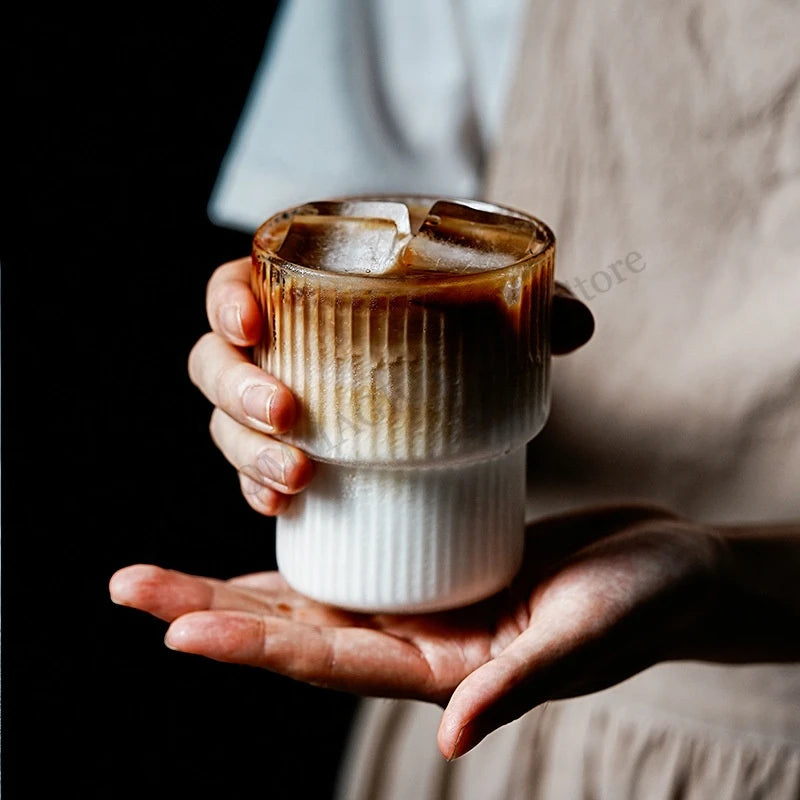 Clear ribbed borosilicate glass latte mug with handleless design, heat-resistant, available in 200ml and 300ml sizes.