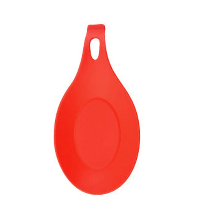 Orange silicone spoon rest by FanzyMarket, heat-resistant and easy to clean utensil cushion for kitchen countertop.