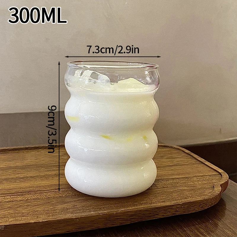 Vertical striped clear glass cup by FanzyMarket, ideal for milk tea, coffee, or juice, featuring an aesthetic, modern design.