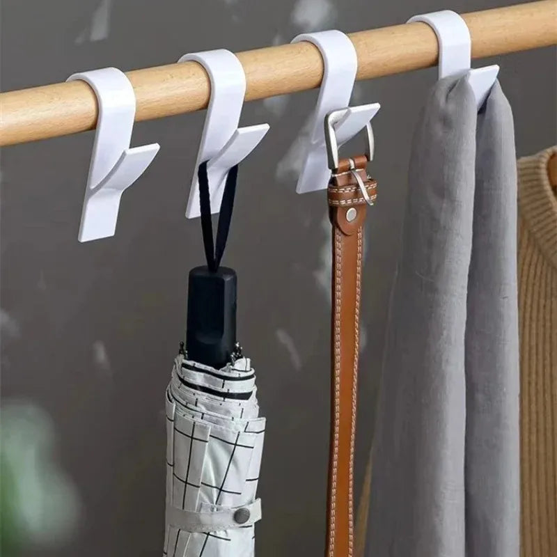 FanzyMarket radiator towel hooks clips on a heated rail, holding towels, scarves, and clothes in a home organization setting.