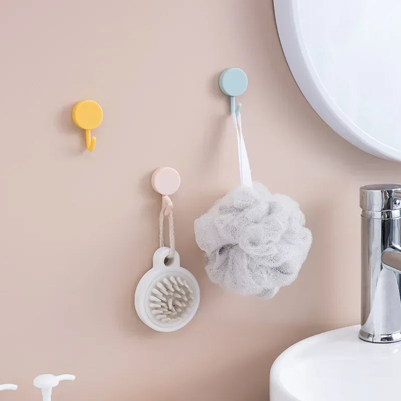 FanzyMarket 10-pack self-adhesive wall hooks for bathroom and kitchen, strong plastic coat towel hangers, no-drill installation.