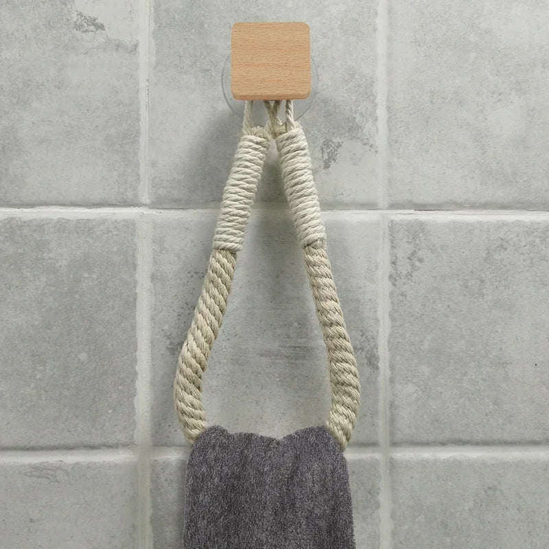 Wall-mounted FanzyMarket nail-free rope paper towel and toilet roll holder with hooks for bathroom or kitchen storage.