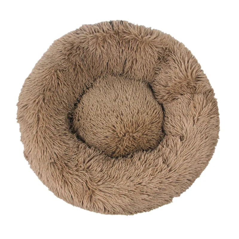 Pink orthopedic donut pet bed by FanzyMarket, soft plush, round calming bed for dogs and cats, washable bolster, fits 15.7-39.4 inches.