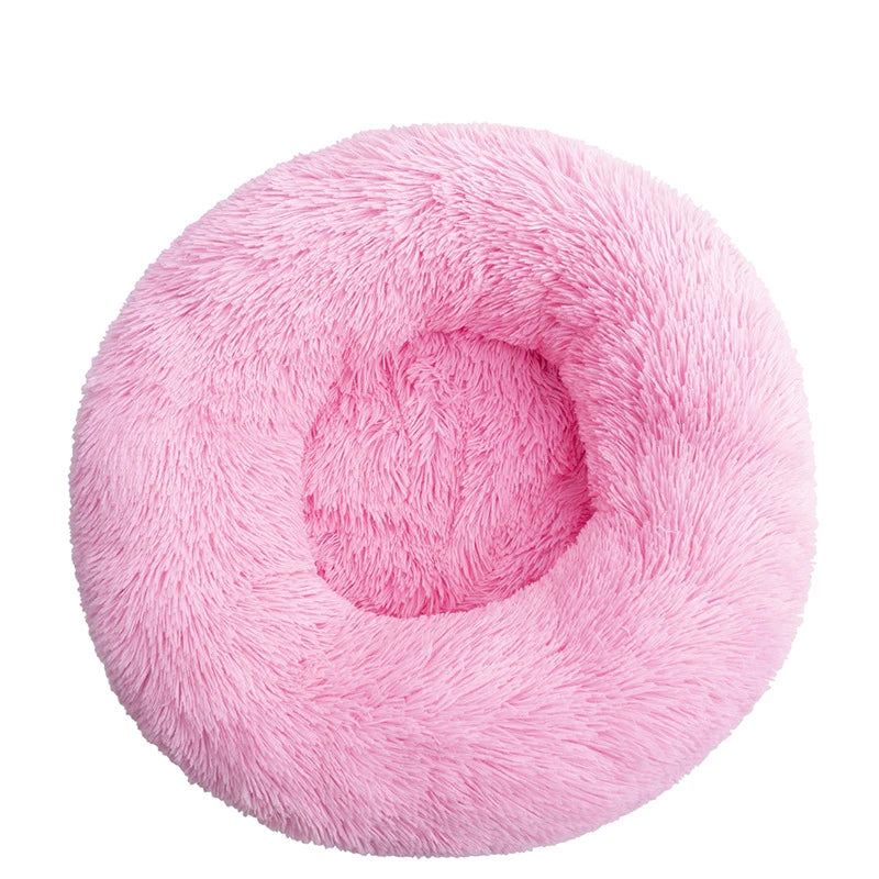 Pink orthopedic donut pet bed by FanzyMarket, soft plush round sofa for dogs and cats, washable and calming for anxiety relief.