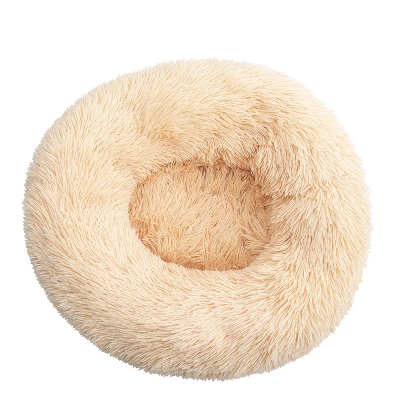 Pink orthopedic donut pet bed by FanzyMarket with plush bolster, ideal for dogs and cats, calming, washable, fits 15.7-39.4 inches.