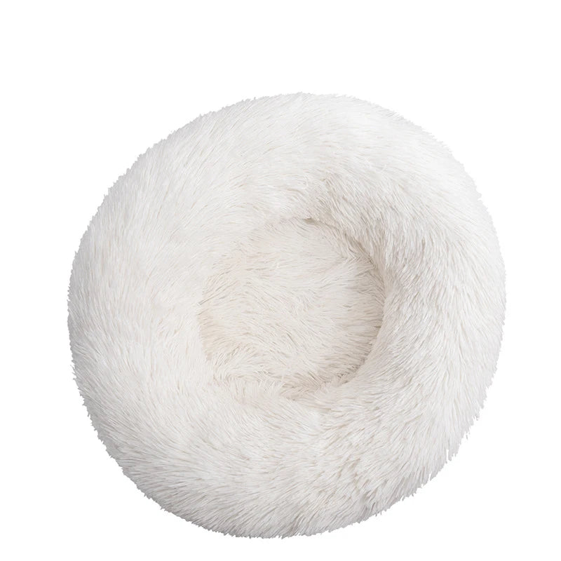 Pink orthopedic donut pet bed by FanzyMarket for dogs and cats, washable plush round sofa with anti-anxiety and cushioning features.