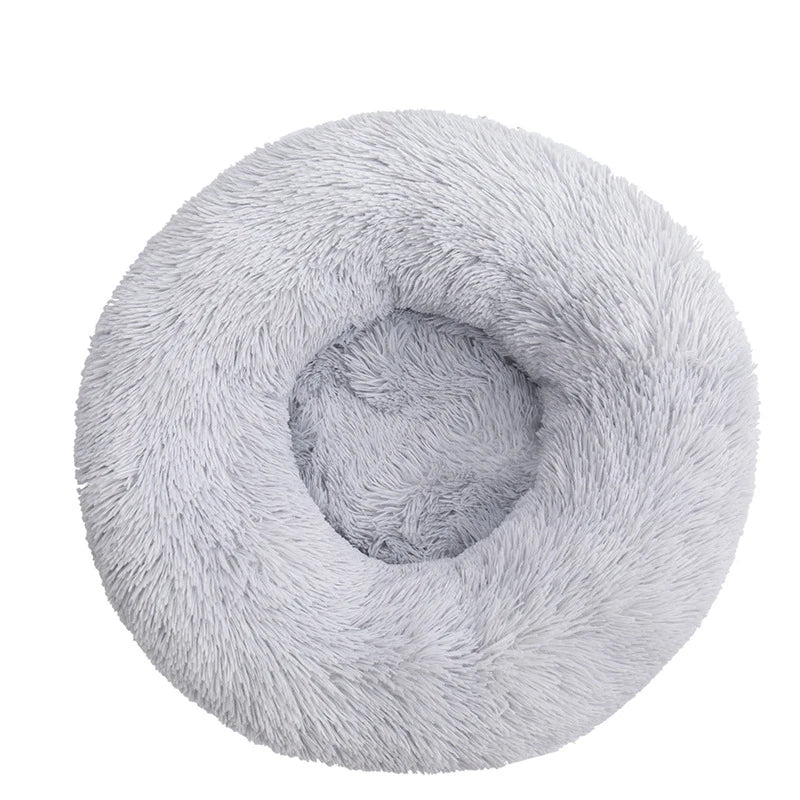 FanzyMarket orthopedic pet bed in soft pink, round donut design with plush bolsters for dogs and cats, washable and calming.