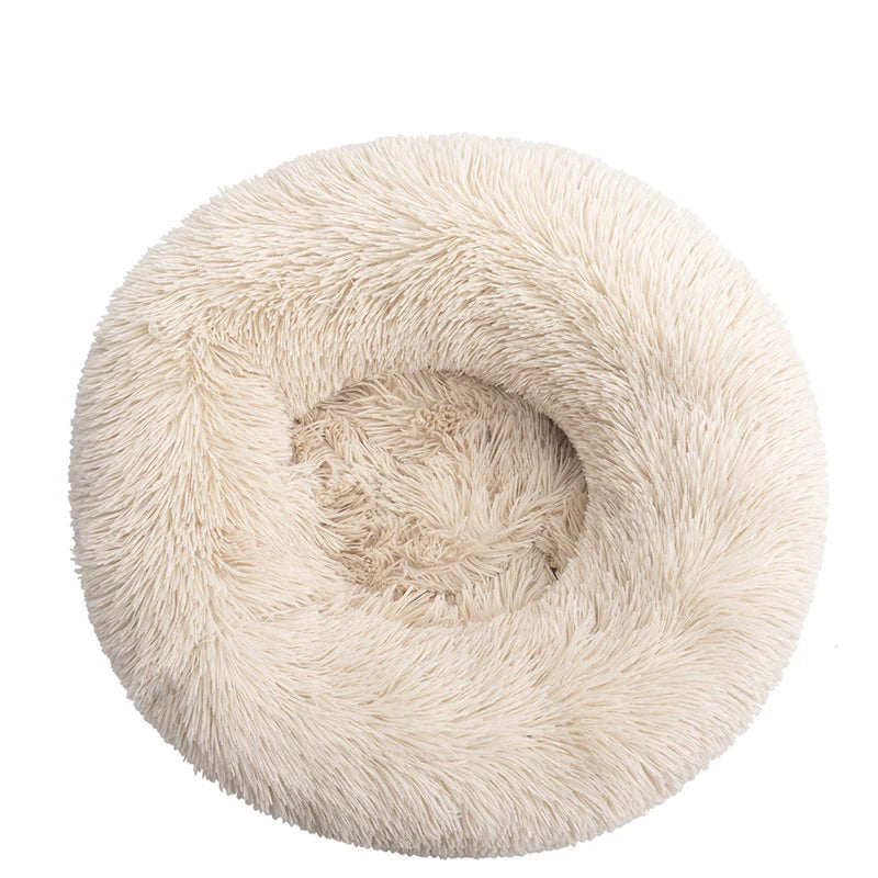Pink orthopedic donut pet bed by FanzyMarket, soft plush round bed for dogs and cats, calming, washable, anti-anxiety design.