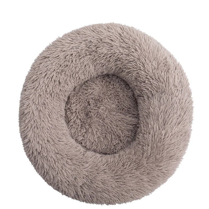 FanzyMarket orthopedic donut pet bed in soft pink, round washable plush sofa for dogs and cats, calming anti-anxiety design.