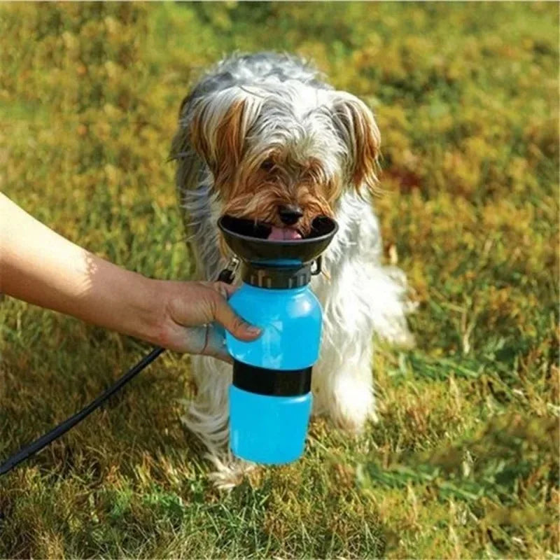 Pink 500ml portable dog and cat travel water bottle with built-in drinking bowl by FanzyMarket for pet feeding and hydration.