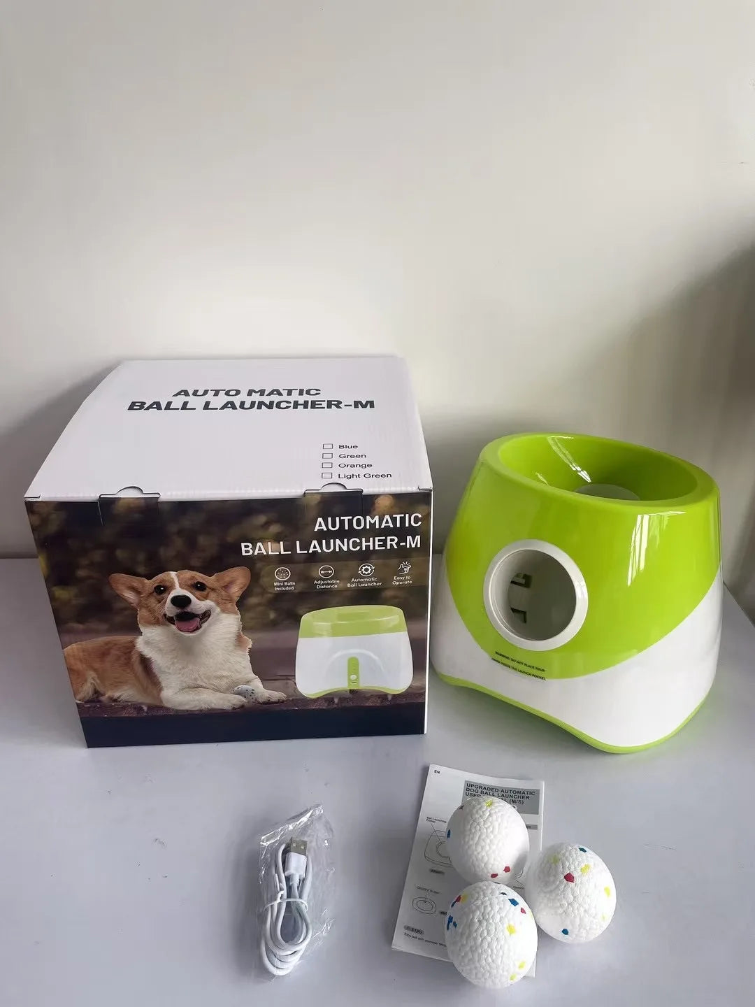 FanzyMarket automatic dog ball launcher with blue design, rechargeable USB, includes 5.8 cm tennis balls for medium and large dogs.