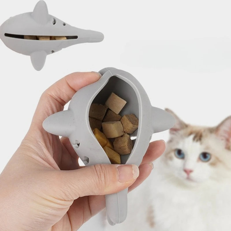 Gray fish-shaped silicone cat toy with treat dispenser and bite-resistant teeth cleaning design for kittens, by FanzyMarket.