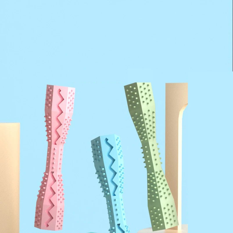 Pink TPR dog chew stick toy from FanzyMarket, bite-resistant treat dispenser and teeth cleaning pet toy for dogs.
