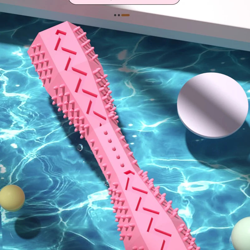 Pink TPR dog chew stick by FanzyMarket, bite-resistant treat-dispensing toy for teeth cleaning and dog entertainment.