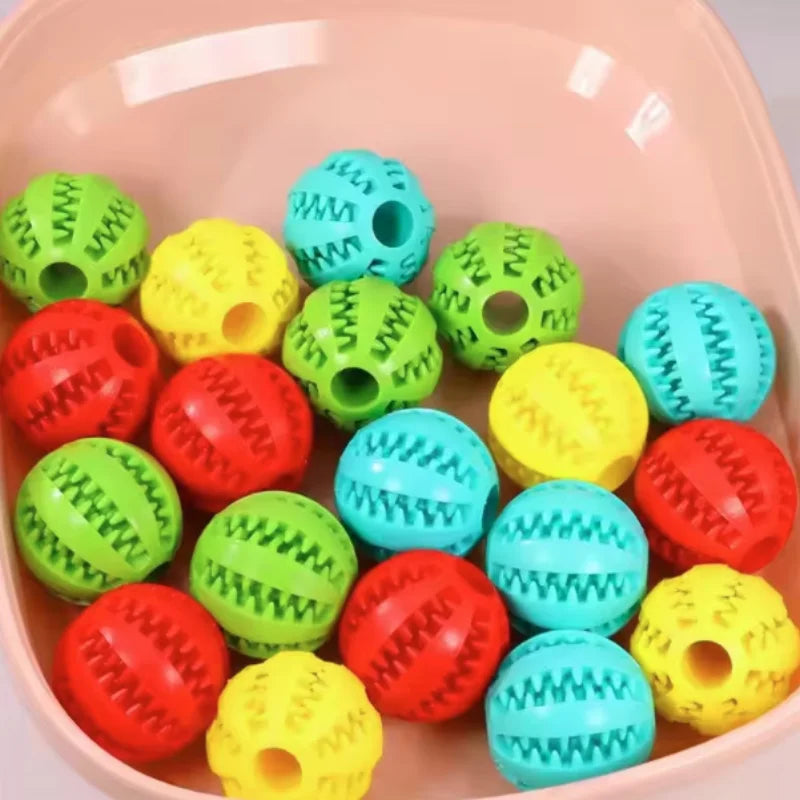 Red interactive rubber dog and cat toy ball, silicone treat feeder and chew toy with textured surface for dental cleaning.