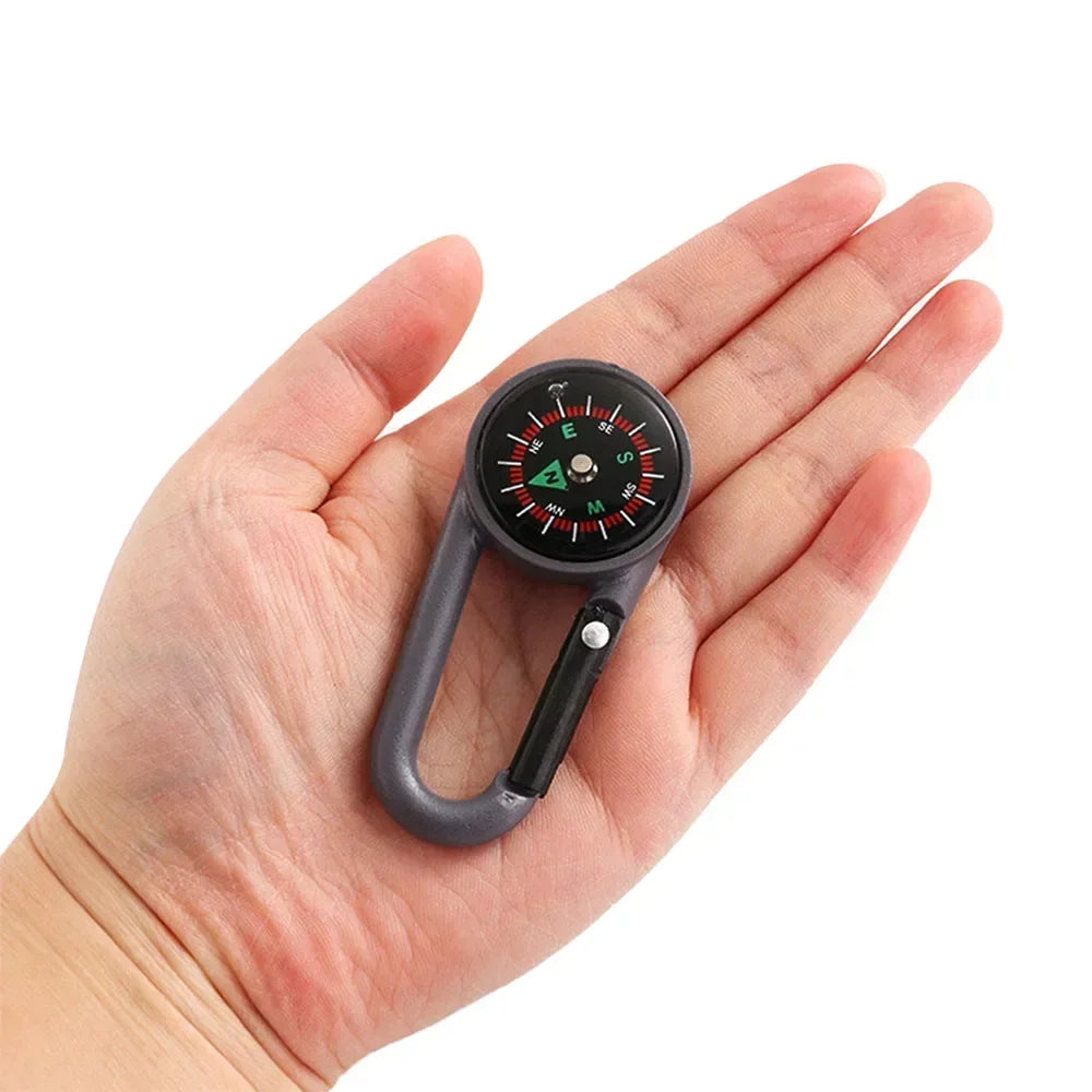 Mini compass carabiner keychain by FanzyMarket, perfect for camping and hiking, attaches to backpacks for outdoor adventures.