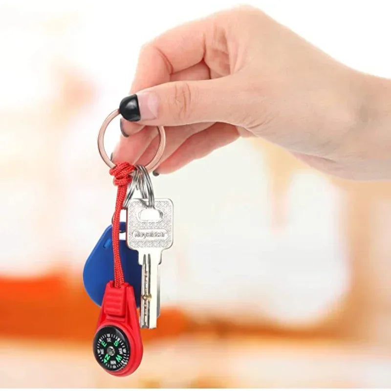 Blue mini tactical pocket compass keychain by FanzyMarket, ideal for camping, hiking, and travel outdoor adventures.
